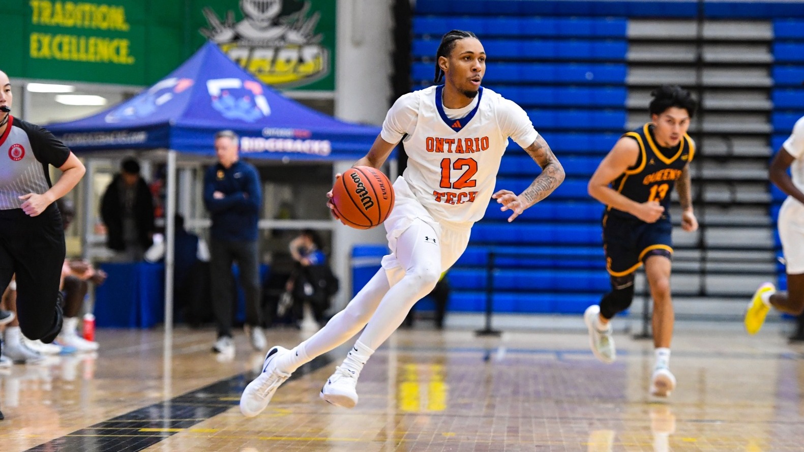 Keon Baker driving with basketball