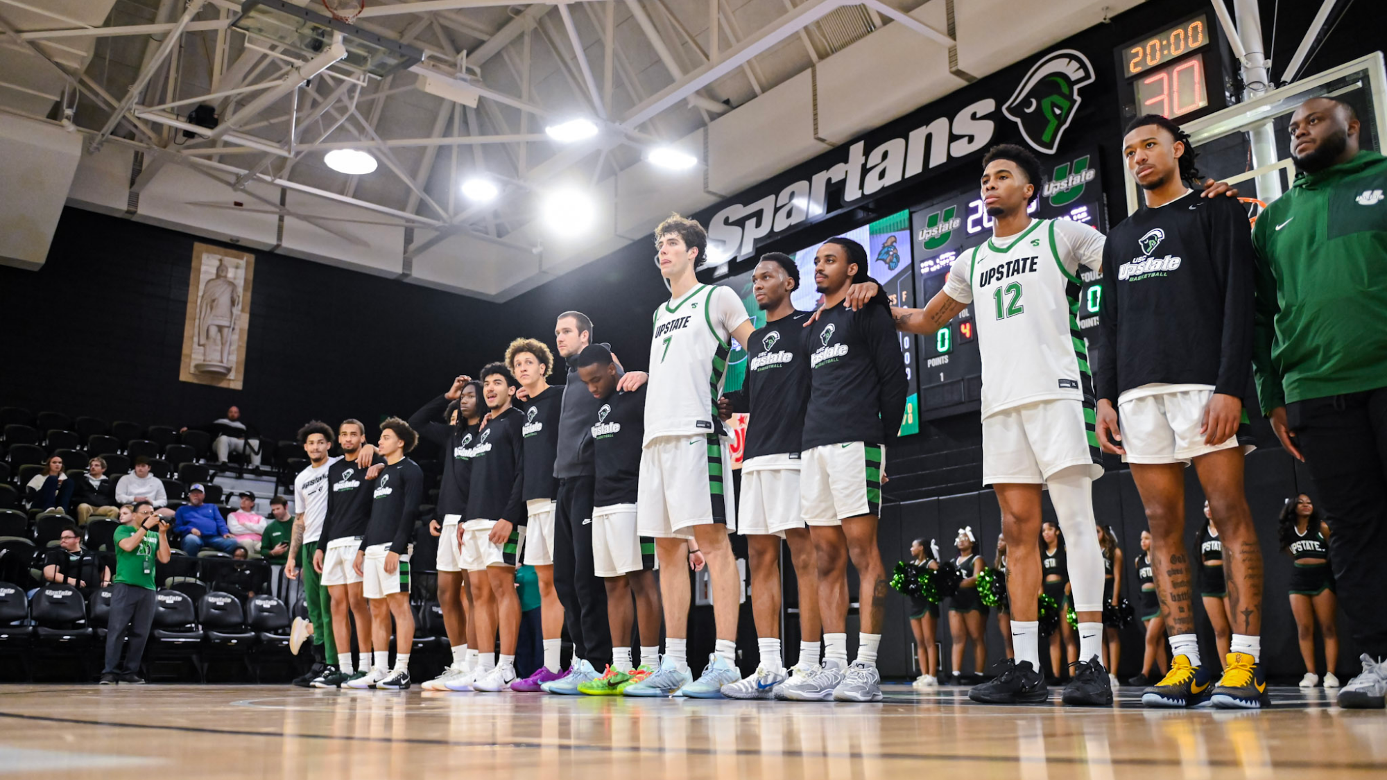 Men's Basketball lining up for the National Anthem against Coastal 