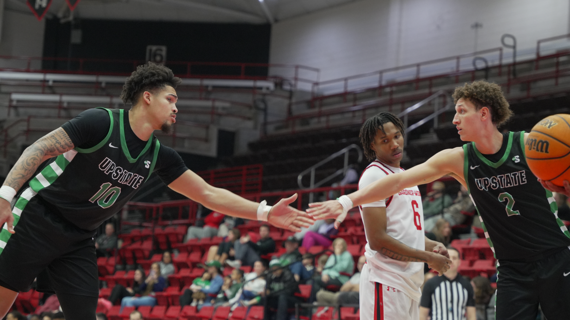 Breylin Garcia and Isaiah Skinner high fives at the Free Throw line
