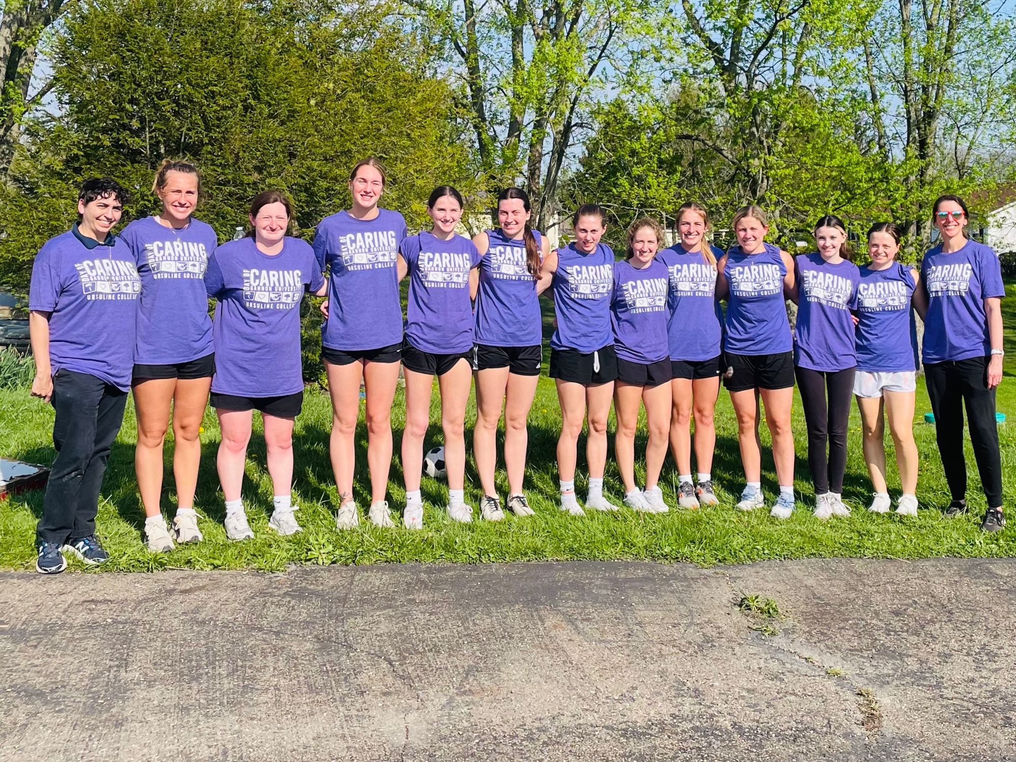 Basketball team takes group photo at 2026 Day of Giving event.