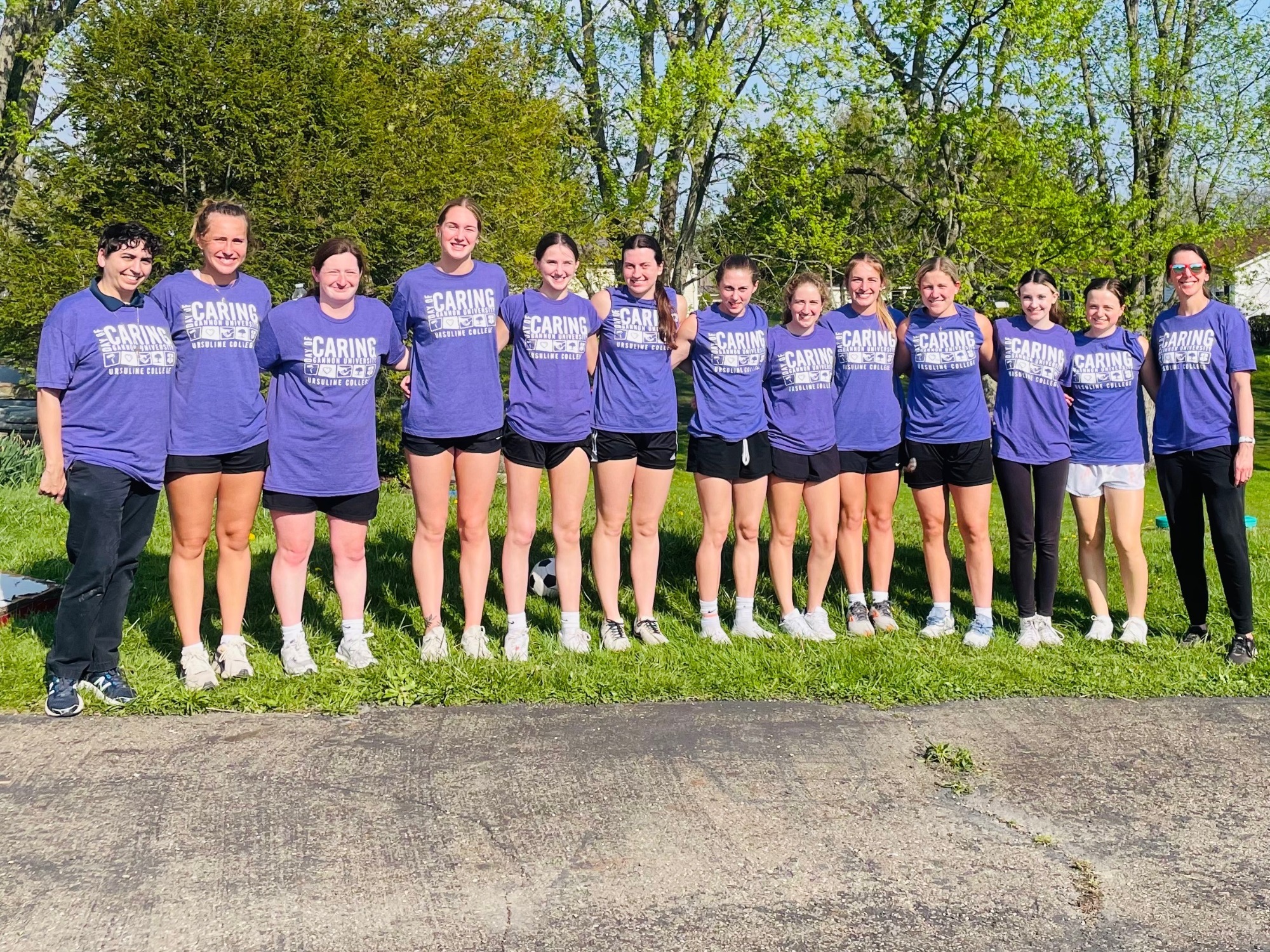 Basketball team takes group photo at 2026 Day of Giving event.