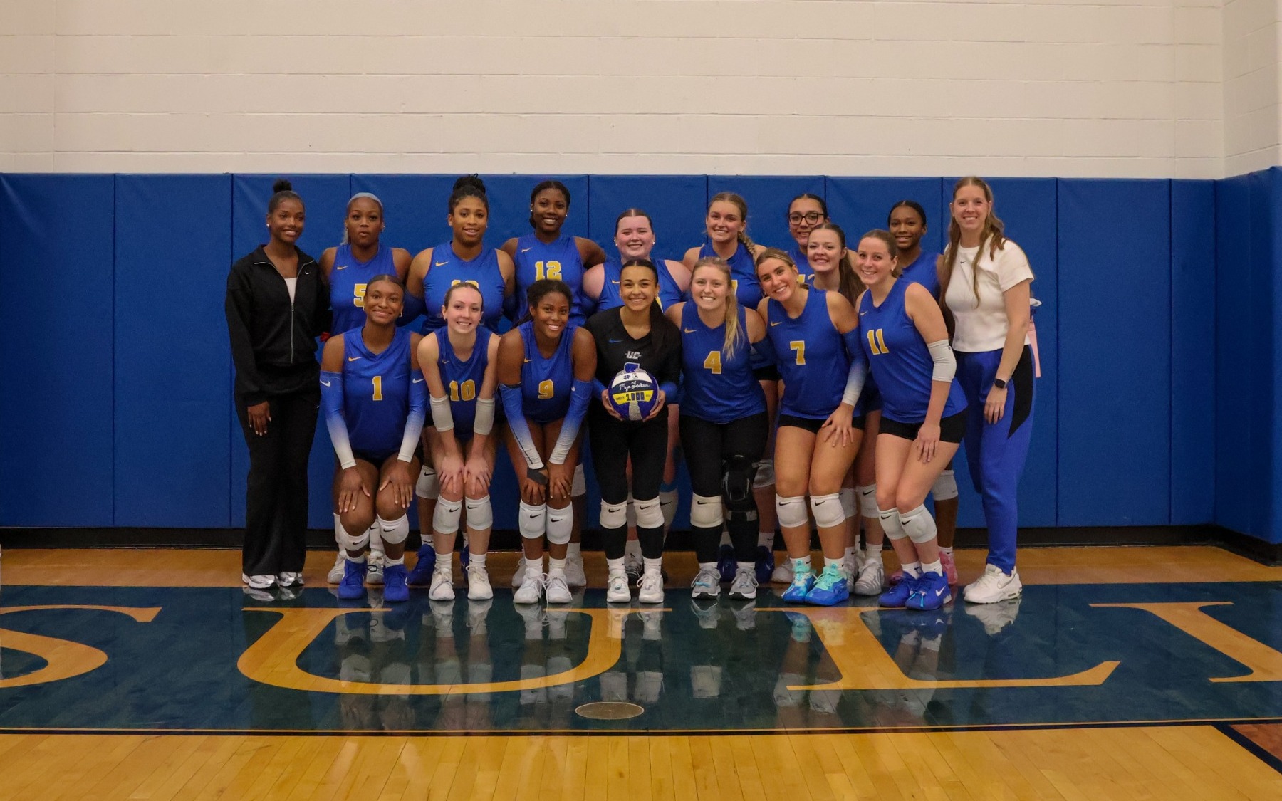 Volleyball Team Photo Celebrating Mya Jackson 1,000 Digs