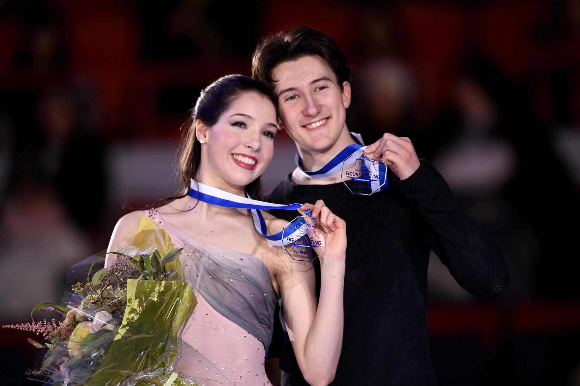 Bronze medalists Lorraine McNamara and Quinn Carpenter of the United States pose on the podium after the ice dance competition at the figure skating ISU Helsinki Grand Prix in Helsinki, Finland on November 3, 2018. (Photo by Martti Kainulainen / Lehtikuva / AFP) / Finland OUT        (Photo credit should read MARTTI KAINULAINEN/AFP/Getty Images)