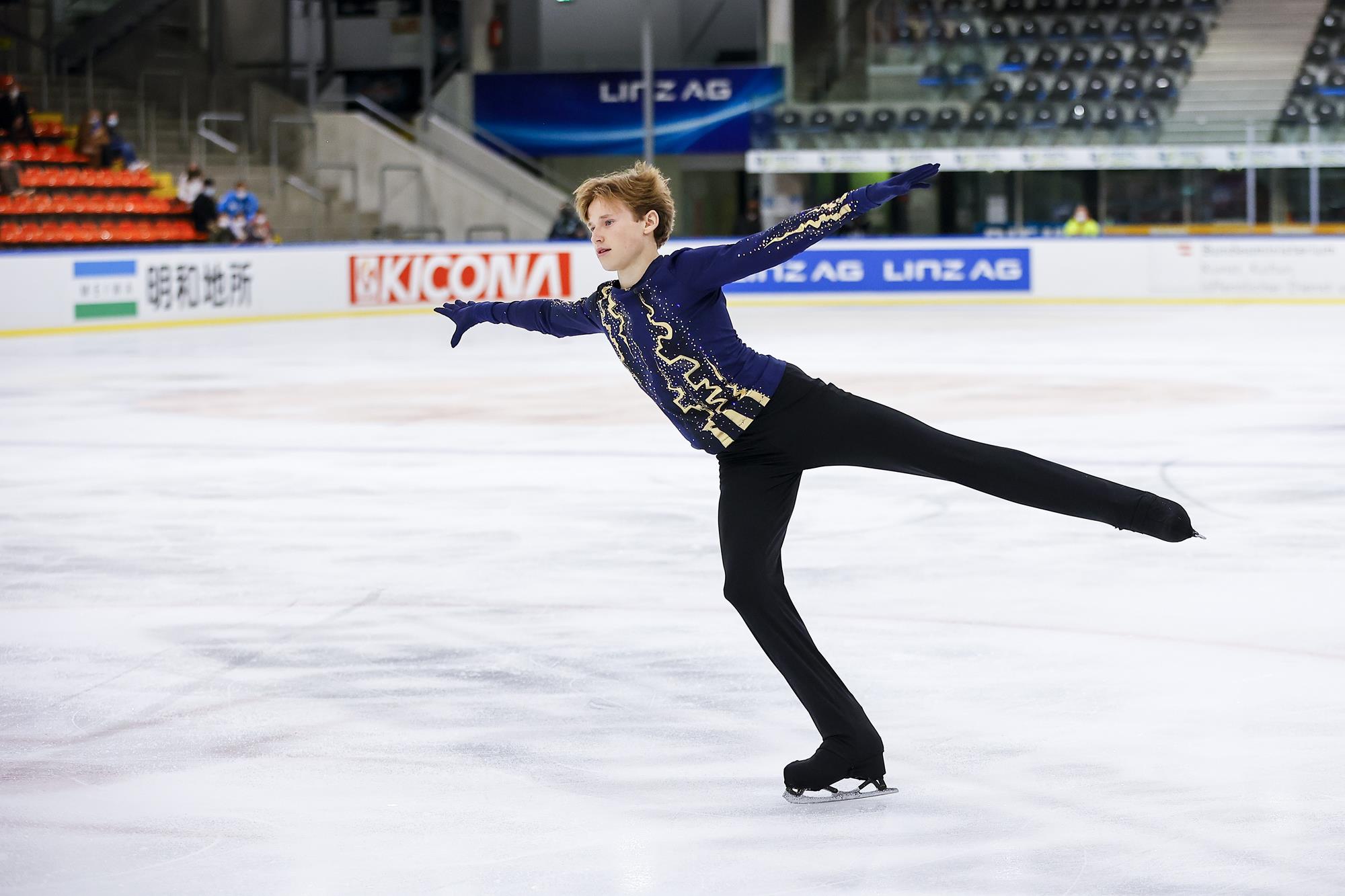 Ilia Malinin in an arabesque position on the ice