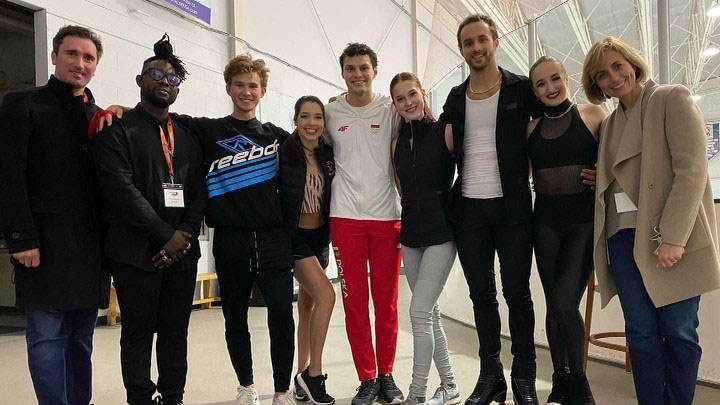 Jimmie Manners poses with skaters and coaches at Ion Figure Skating Club