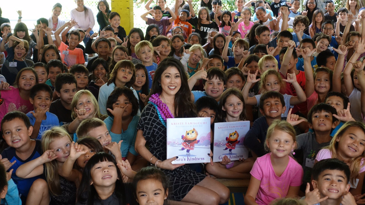 Kristi Yamaguchi poses with kids in her Always Dream program