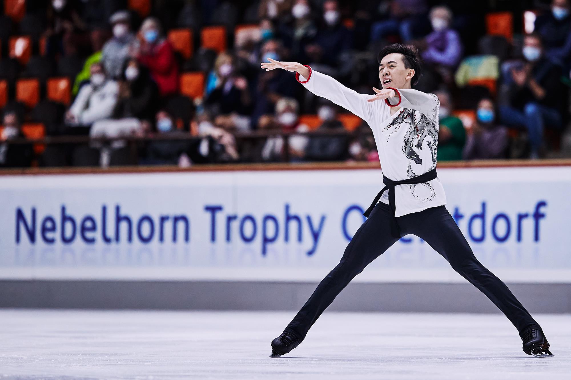 Vincent Zhou competes at Nebelhorn wearing a white and red costume