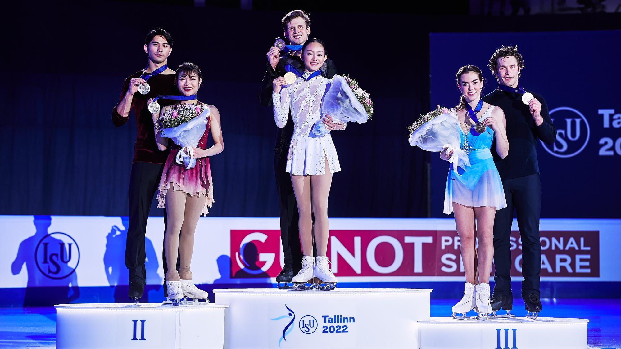 Audrey Lu and Misha Mitrofanov and Emily Chan and Spencer Howe hold their medals on the podium.