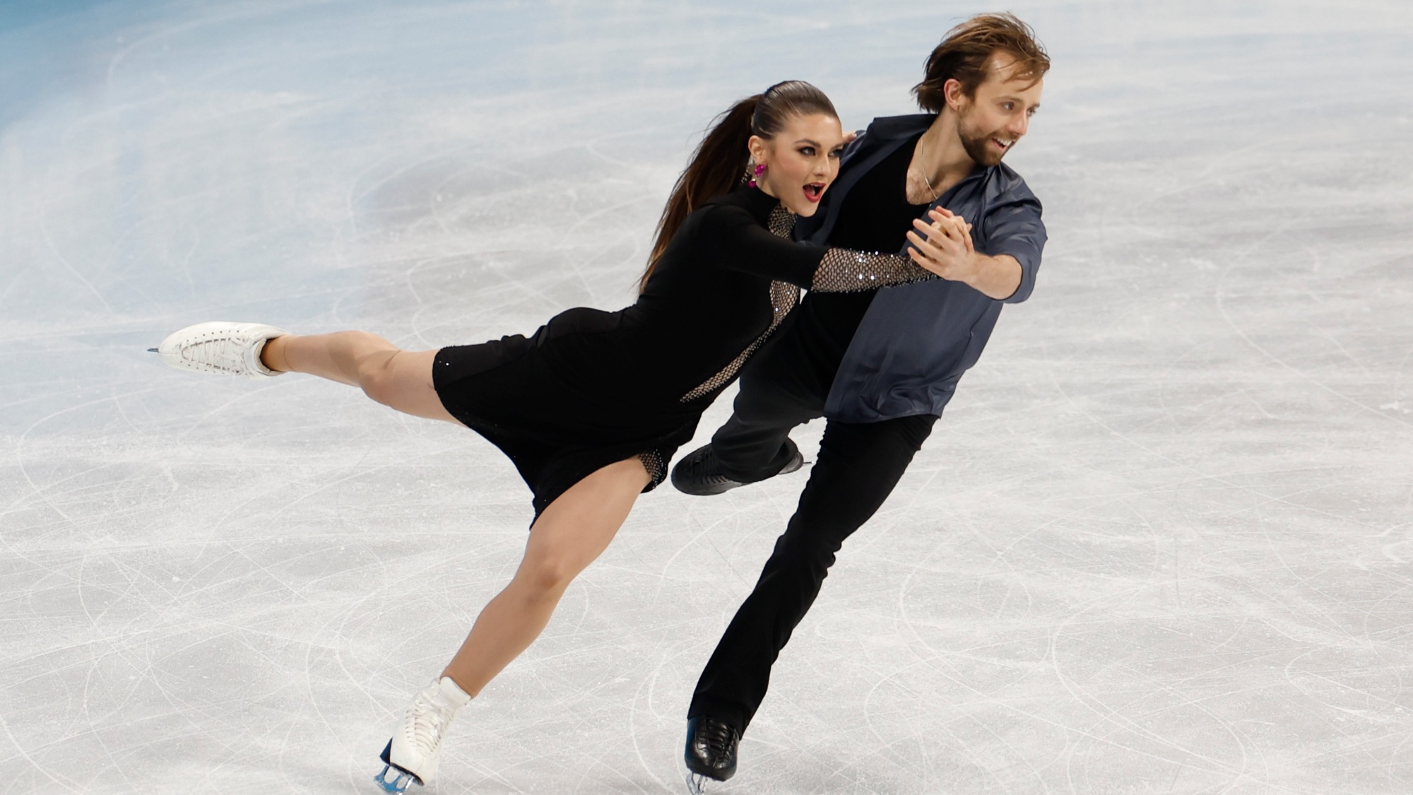 Kaitlin Hawayek and Jean-Luc Baker skate in hold.