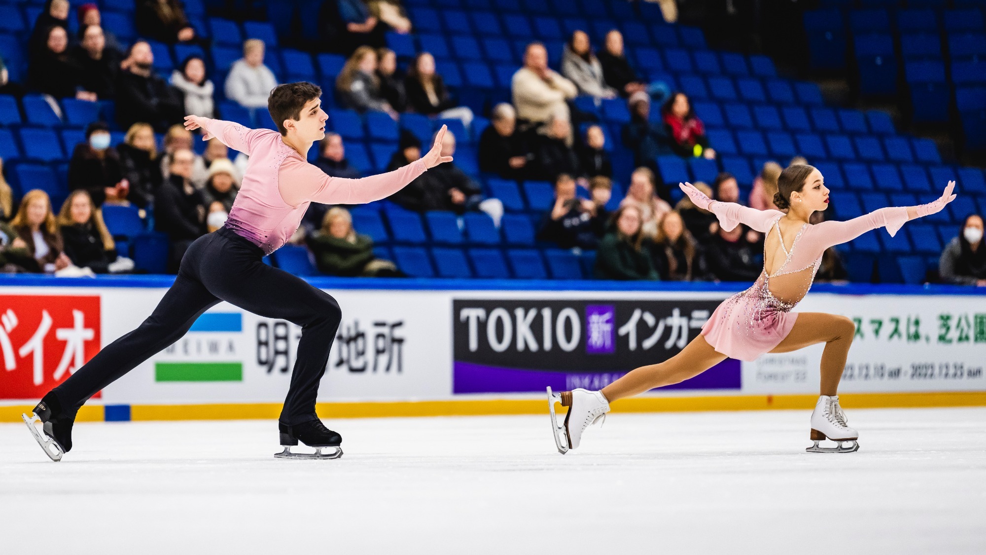 Anastasiia Smirnova and Daniel Siianytsia perform side by side, reaching out in front of them.