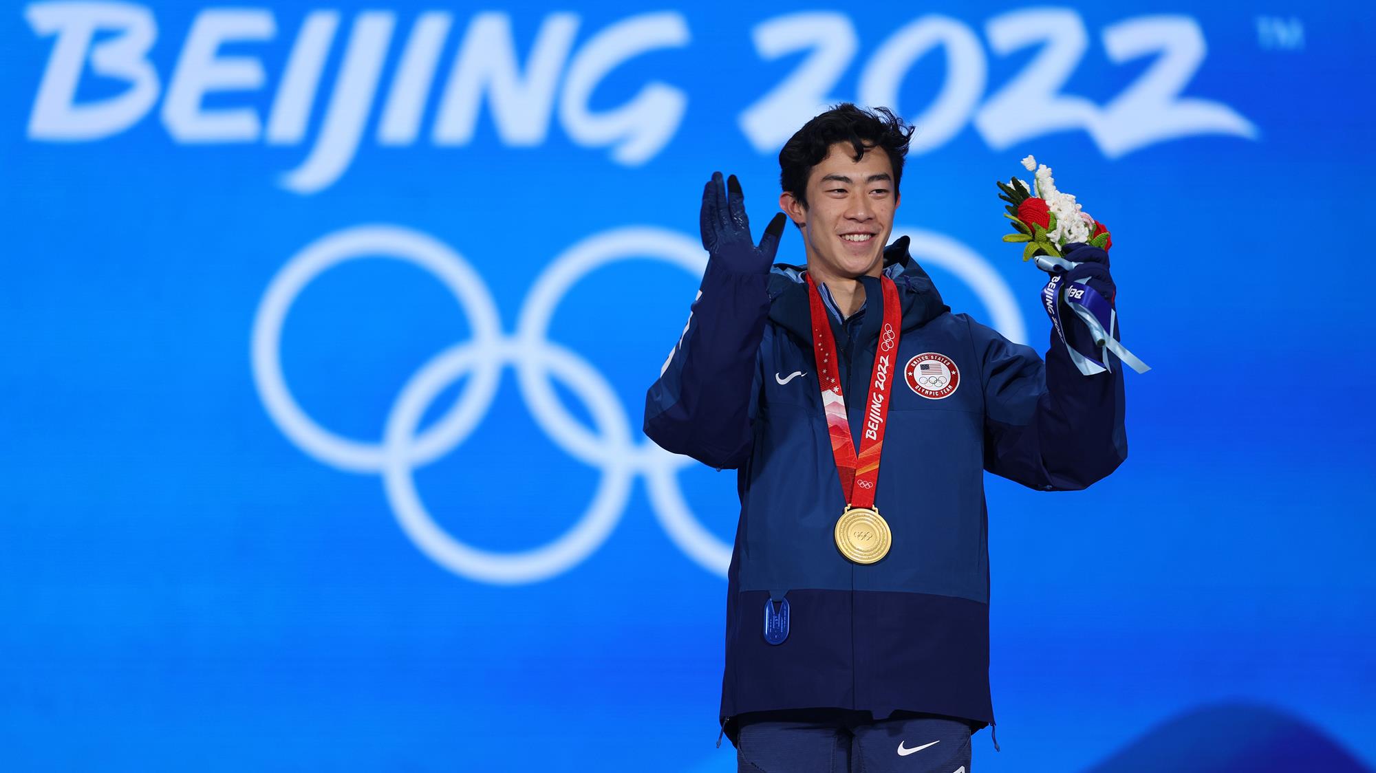 Nathan Chen waves to the crowd during his gold-medal ceremony in Beijing