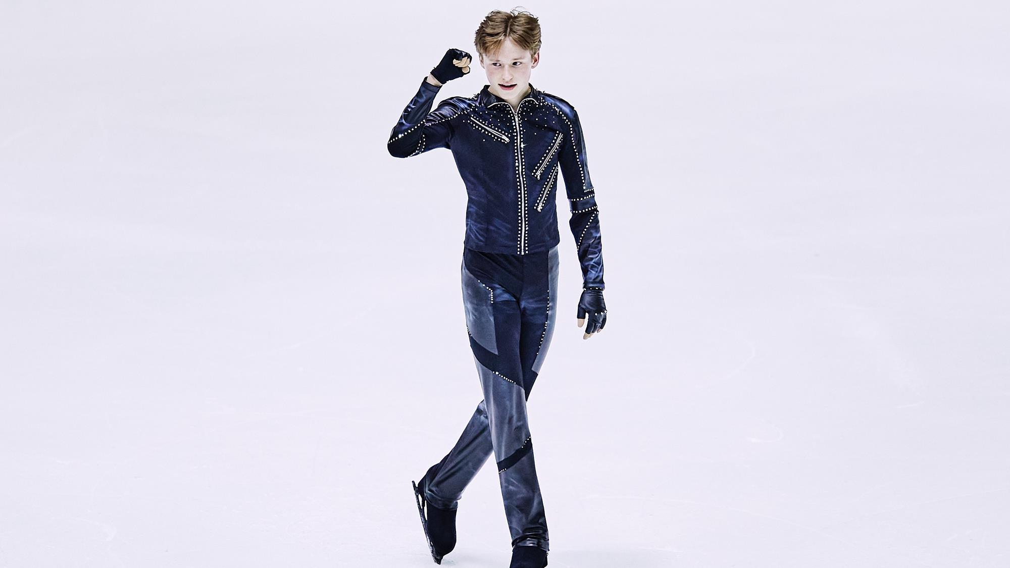 Ilia Malinin pumps his fist after his short program at the World Junior Championships.