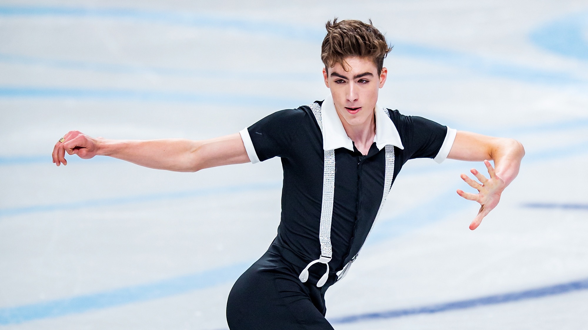 Eric Sjoberg wears a black shirt with white suspenders and white collar as he performs.