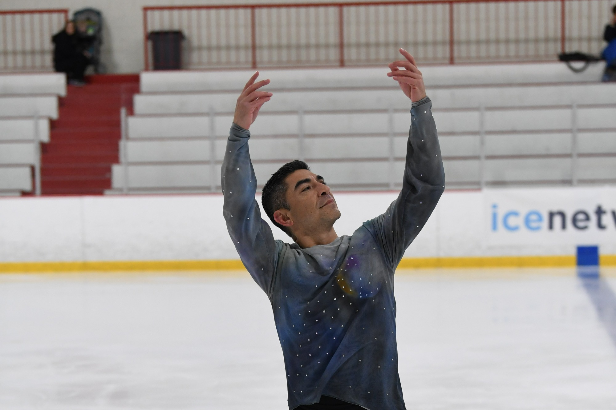 Roland Jarquio with his arms over his head in a spread eagle element.