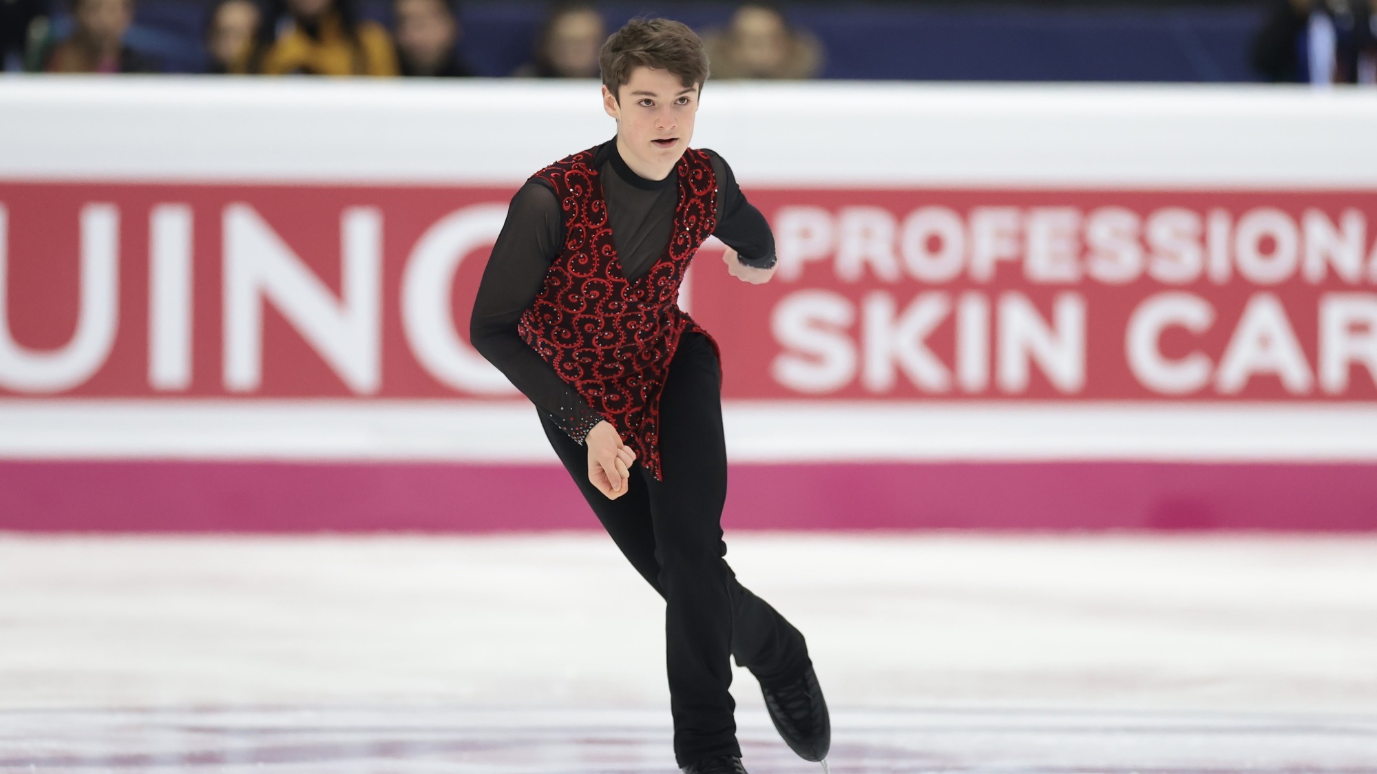 Lucas Broussard skates forward, focused, during his short program at the 2022 Junior Grand Prix Final.