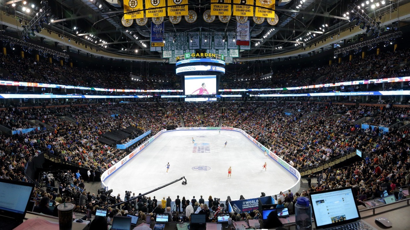 A shot from above of the ice rink and arena bowl from the 2016 World Championships. The stands are full and there are skaters out on the ice during warm up.