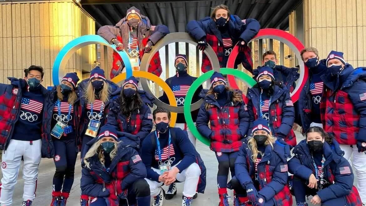 The 2022 U.S. Olympic Figure Skating Team poses for a picture with the Olympic rings in Beijing.