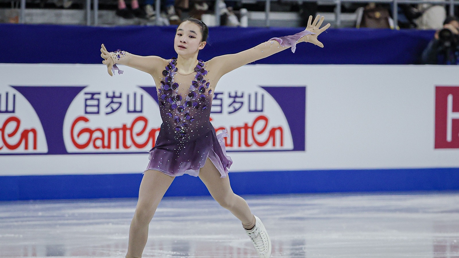 Dressed in purple, Elyce Lin-Gracey glides across the ice at the Four Continents Championships.