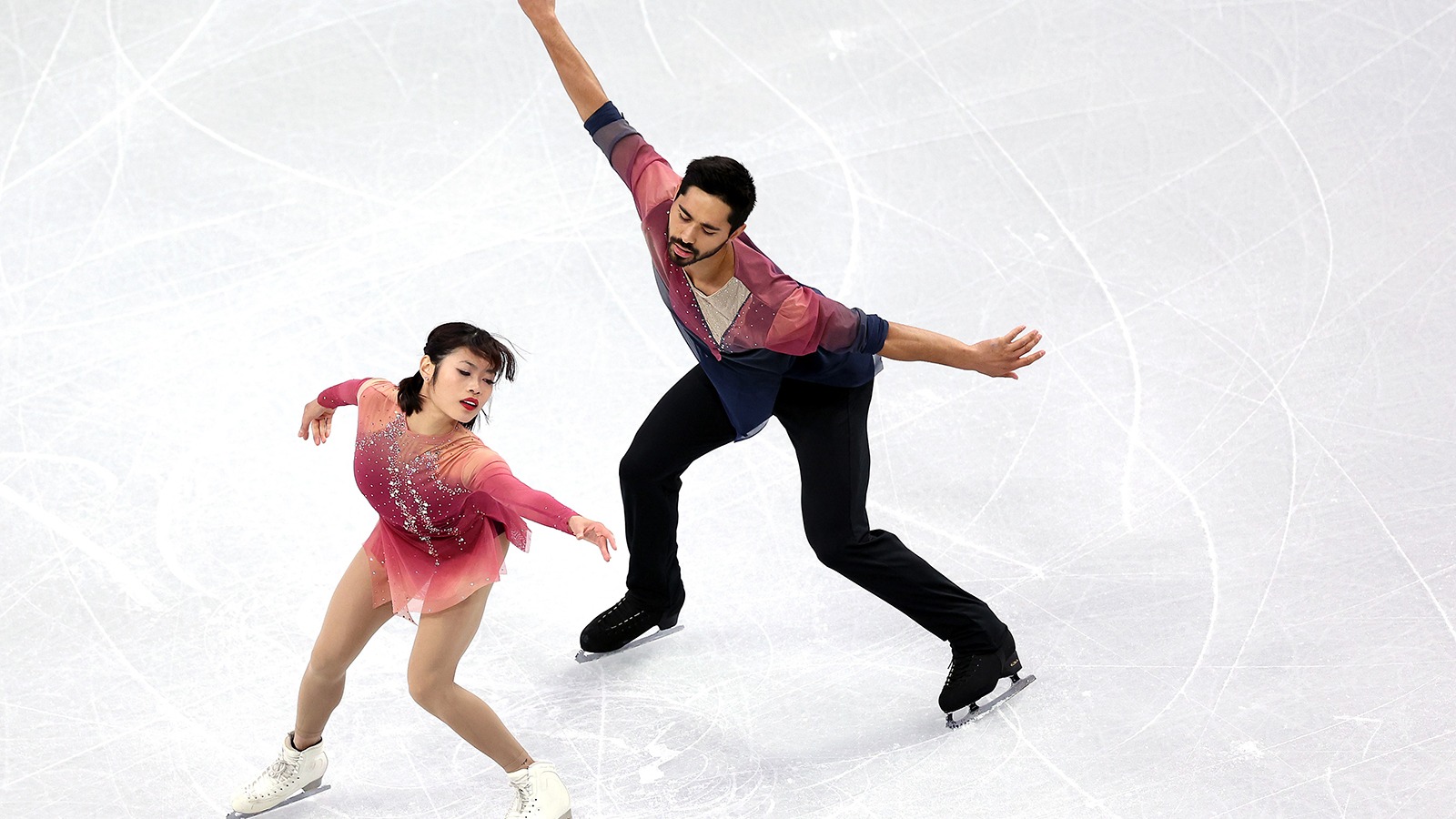 Arms extended, not touching, Emily Chan, in front, and Spencer Howe, in back, show their grace and unison at Skate Canada.