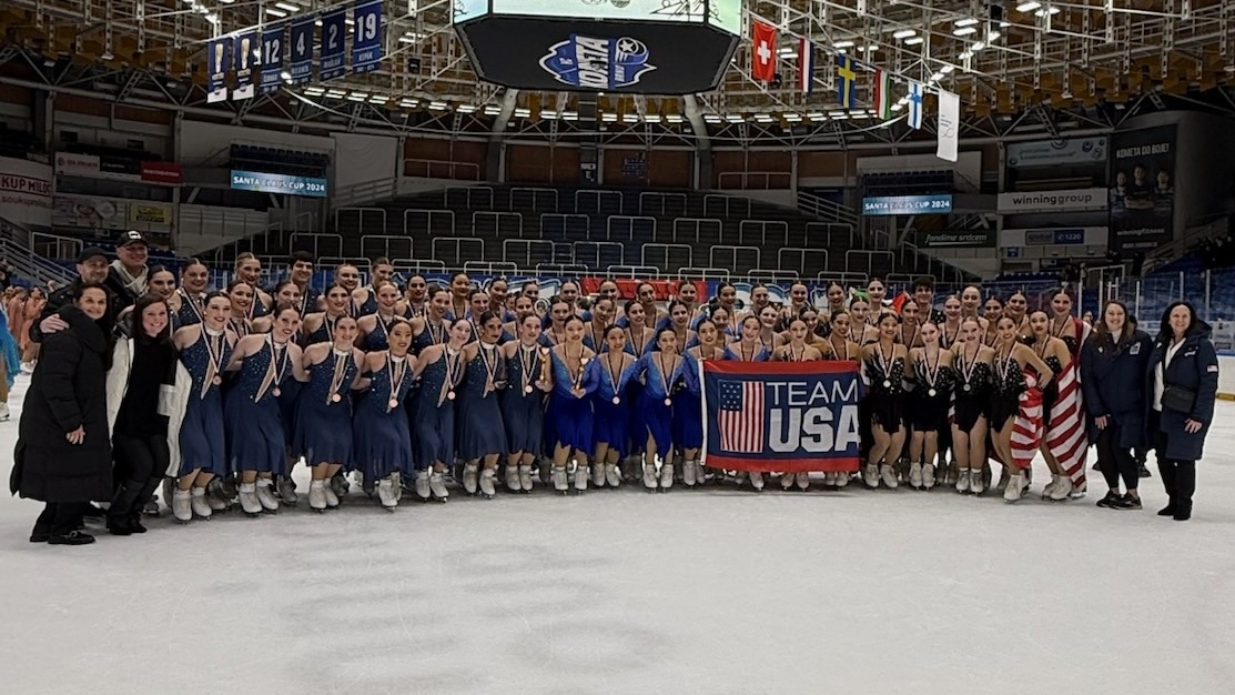 The Skyliners, Skyliners junior and Teams Elite pose for a photo on the ice with their coaches after receiving their medals at Santa Claus Cup.