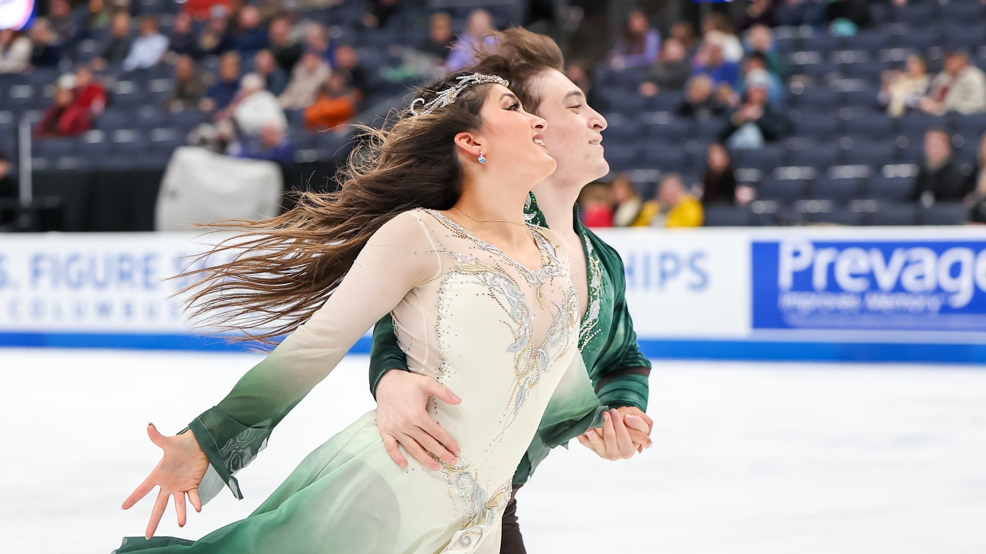 Dressed in green and white, Elliana Peal and brother Ethan Peal glide side by side.