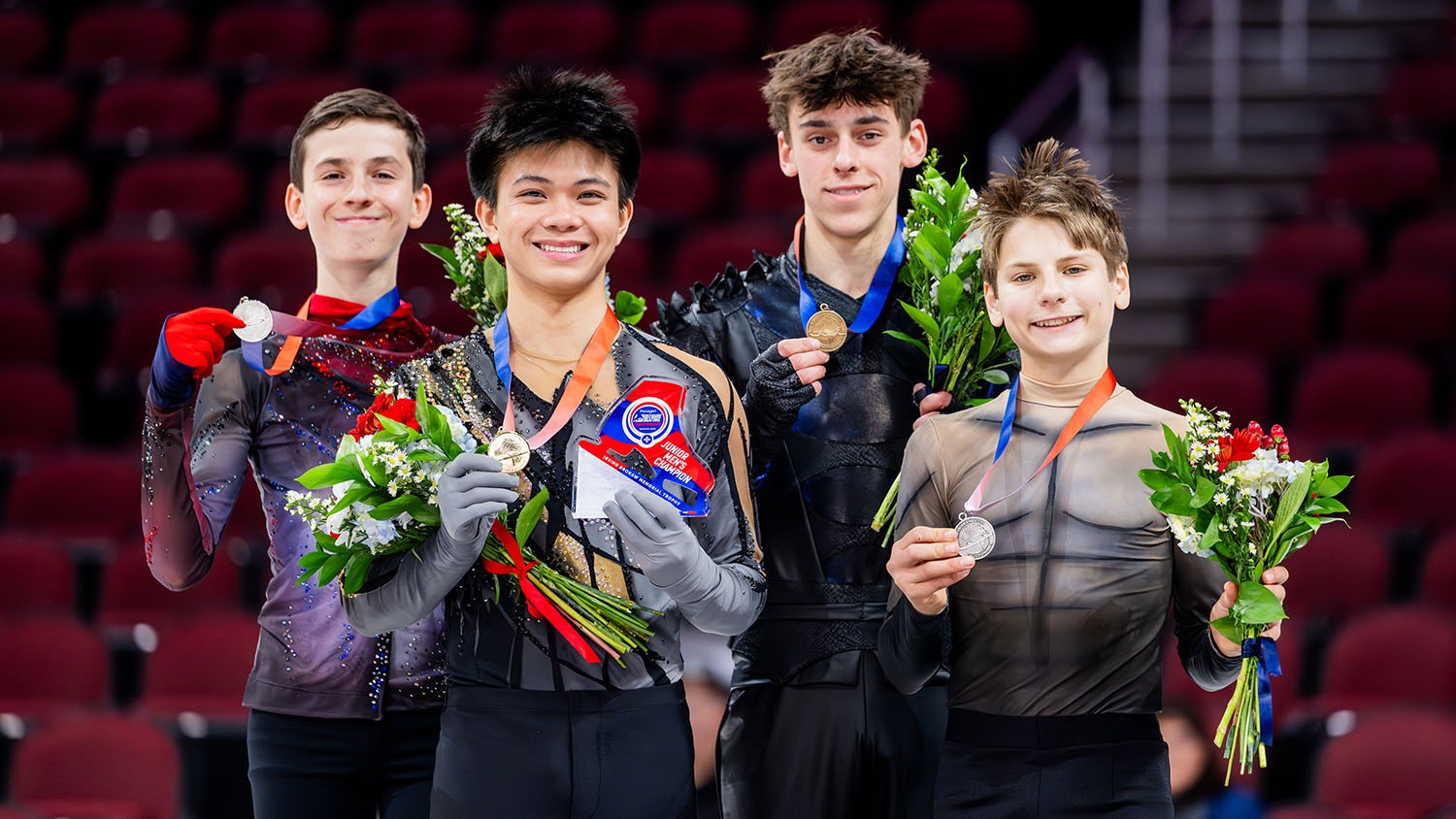 The junior men's medalists stand next to each other and smile while holding up their medals: Aleksandr Fegan, Lorenzo Elano, Patrick Blackwell and Kirk Haugeto.