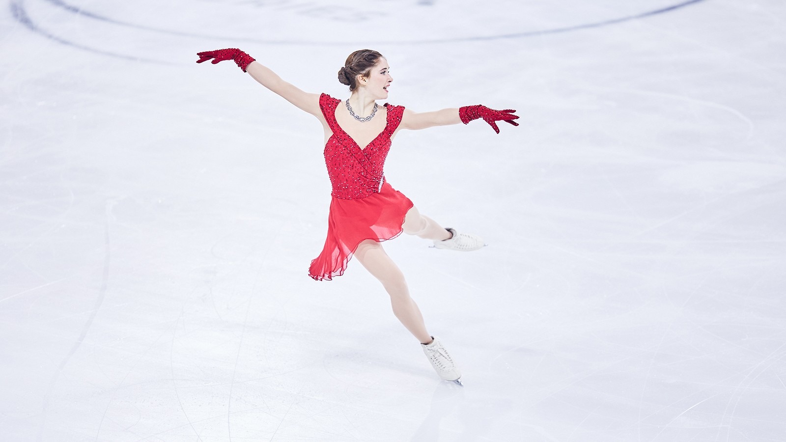 Isabeau Levito, dressed in red with red gloves, performs her short program to music from Sophia Loren movies.