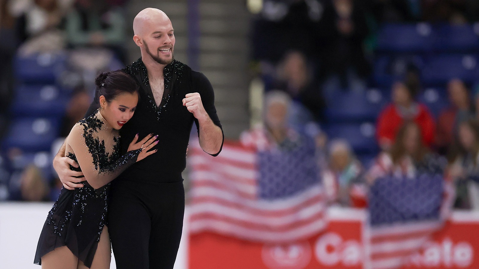 Ellie Kam and Danny O'Shea happily skate off the ice together after their stellar free skate at Skate Canada International