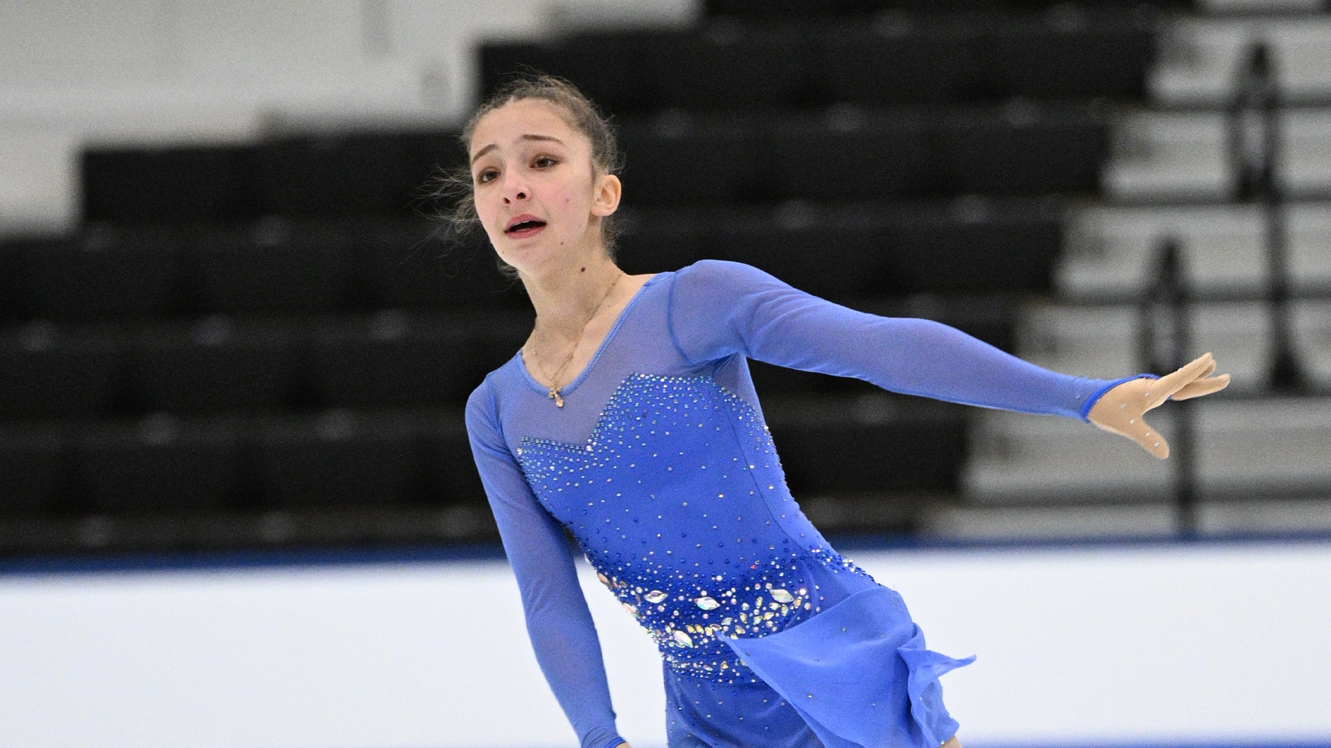 Photo of Olivia Eve Ter. She is a young girl wearing a long sleeve purple skating costume