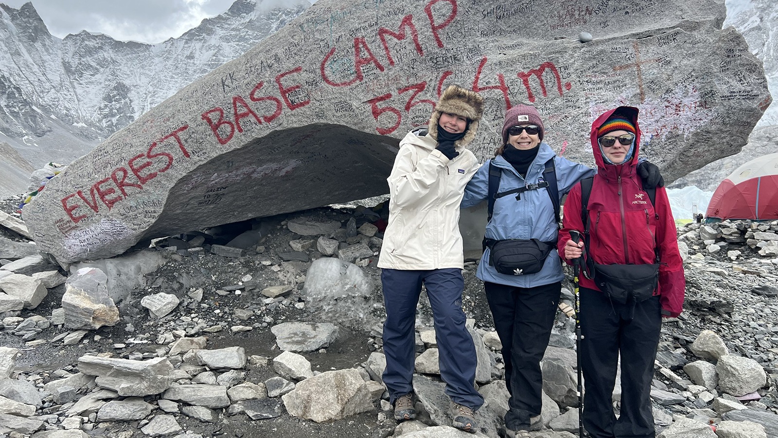 Alysa Liu stands in front of the Mount Everest Base Camp sign with friends