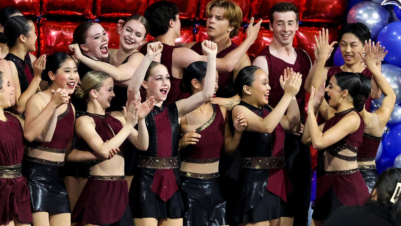 U.S. junior champion Sophie Joline von Felten, arms extended upward, celebrates Act 1 of Boston's victory at National Theatre on Ice. 
