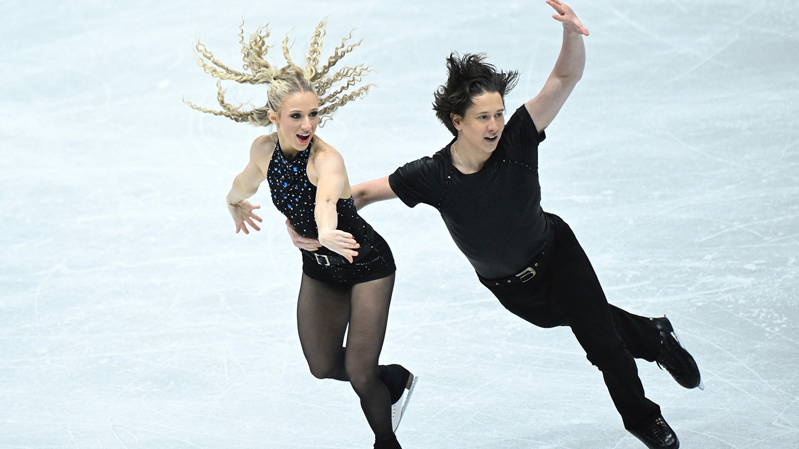 Emilea Zingas and Vadym Kolesnik, dressed in black, perform their electric rhythm dance at the Four Continents Championships.