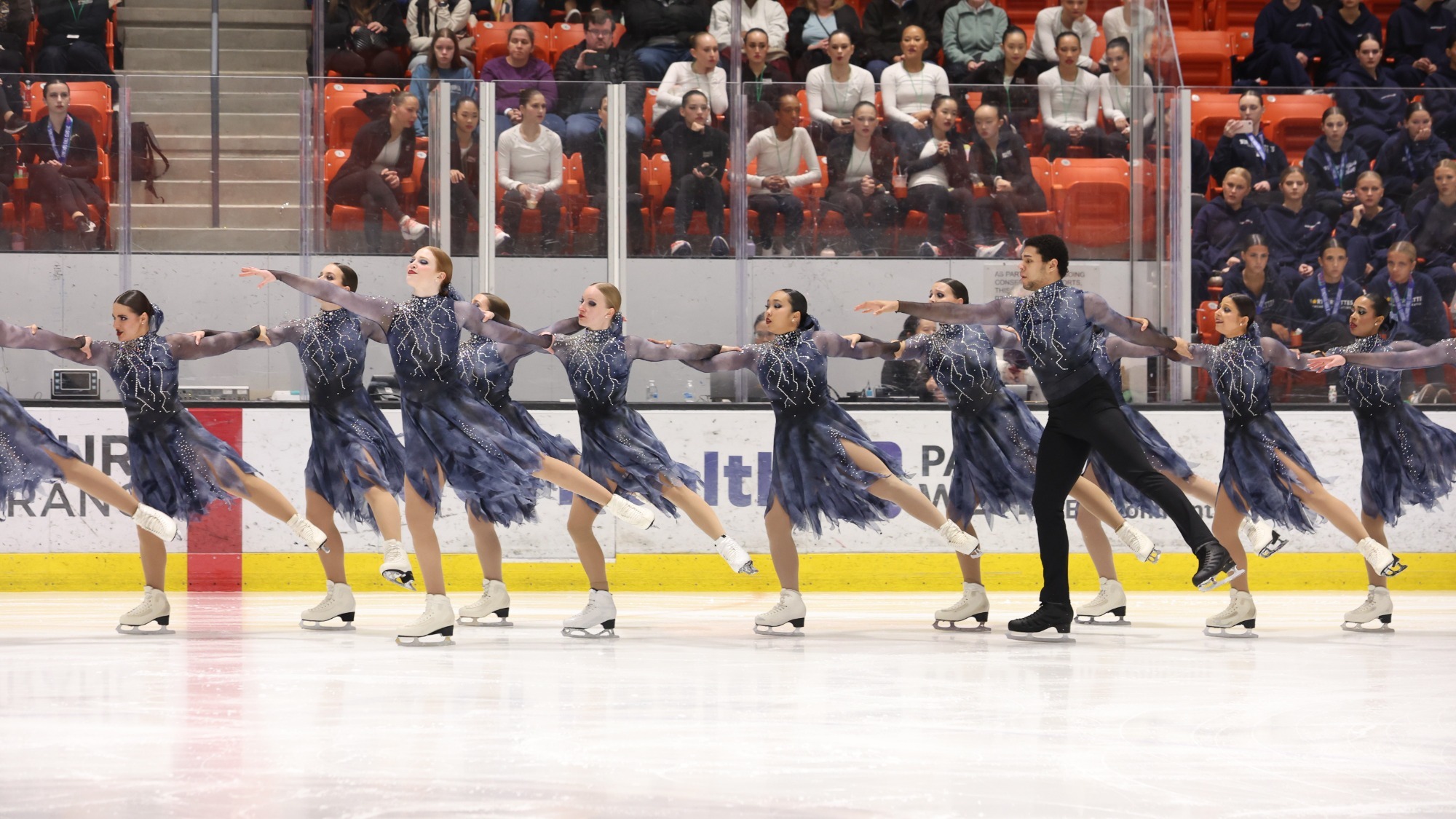 Teams Elite, dressed in gray, display their unison at a event last fall.