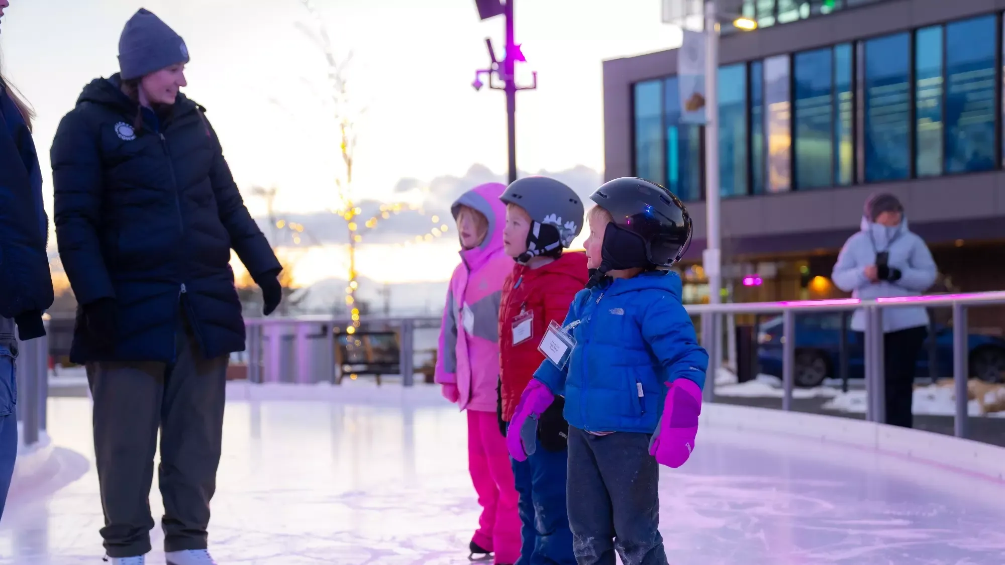 Jamie Wilner, blue coat, teaches the basics to three young children. 