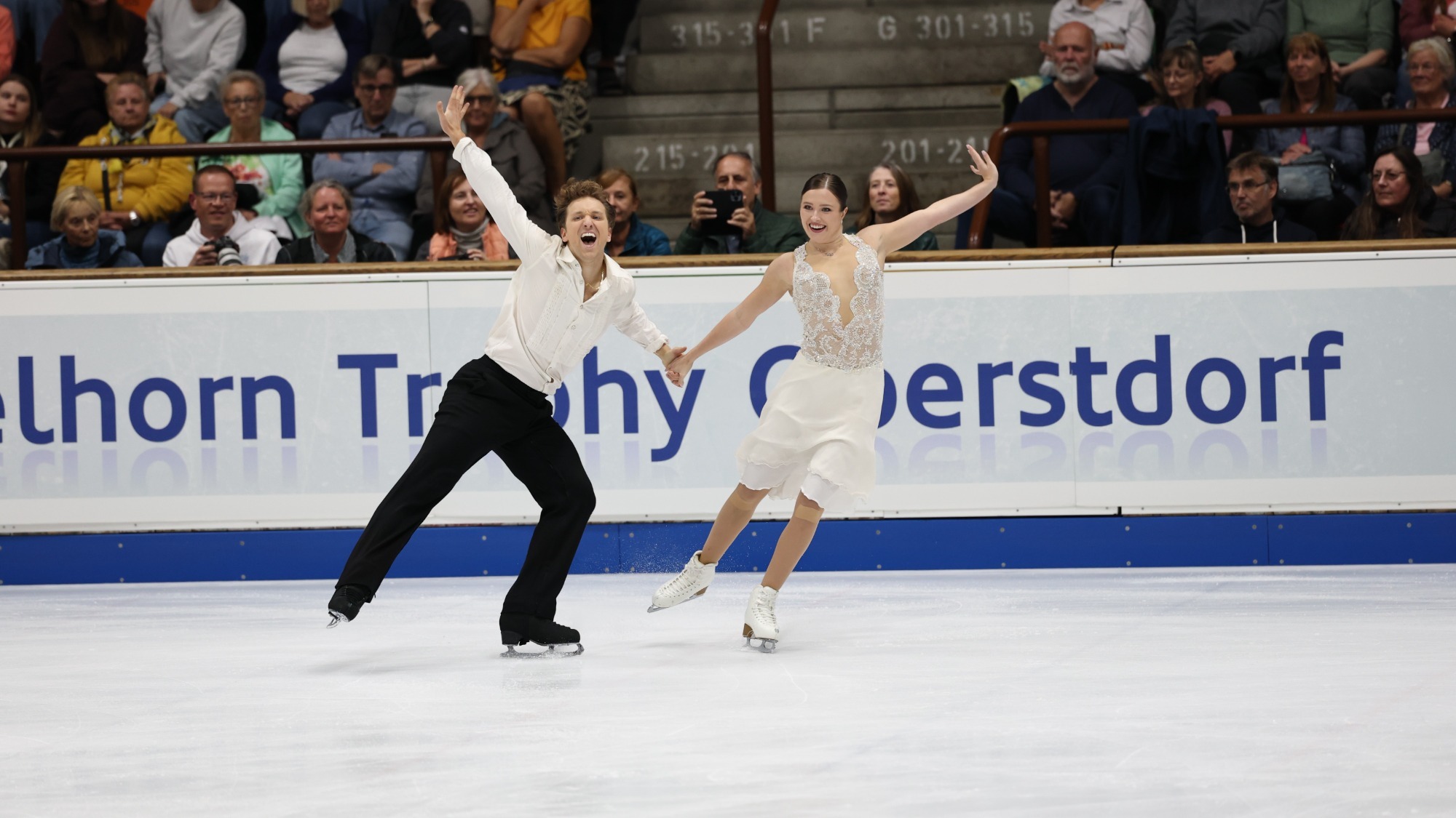 Christina Carreira and Anthony Ponomarenko display their joy en route to the title at the Nebelhorn Trophy