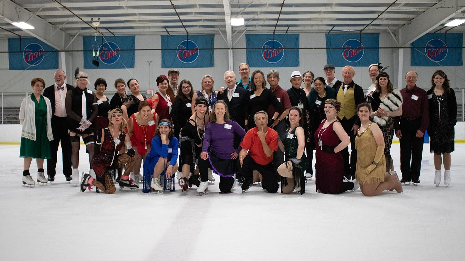 Adult skaters stand together at center ice, enjoying the 2019 Atlanta Ice Dance Weekend.