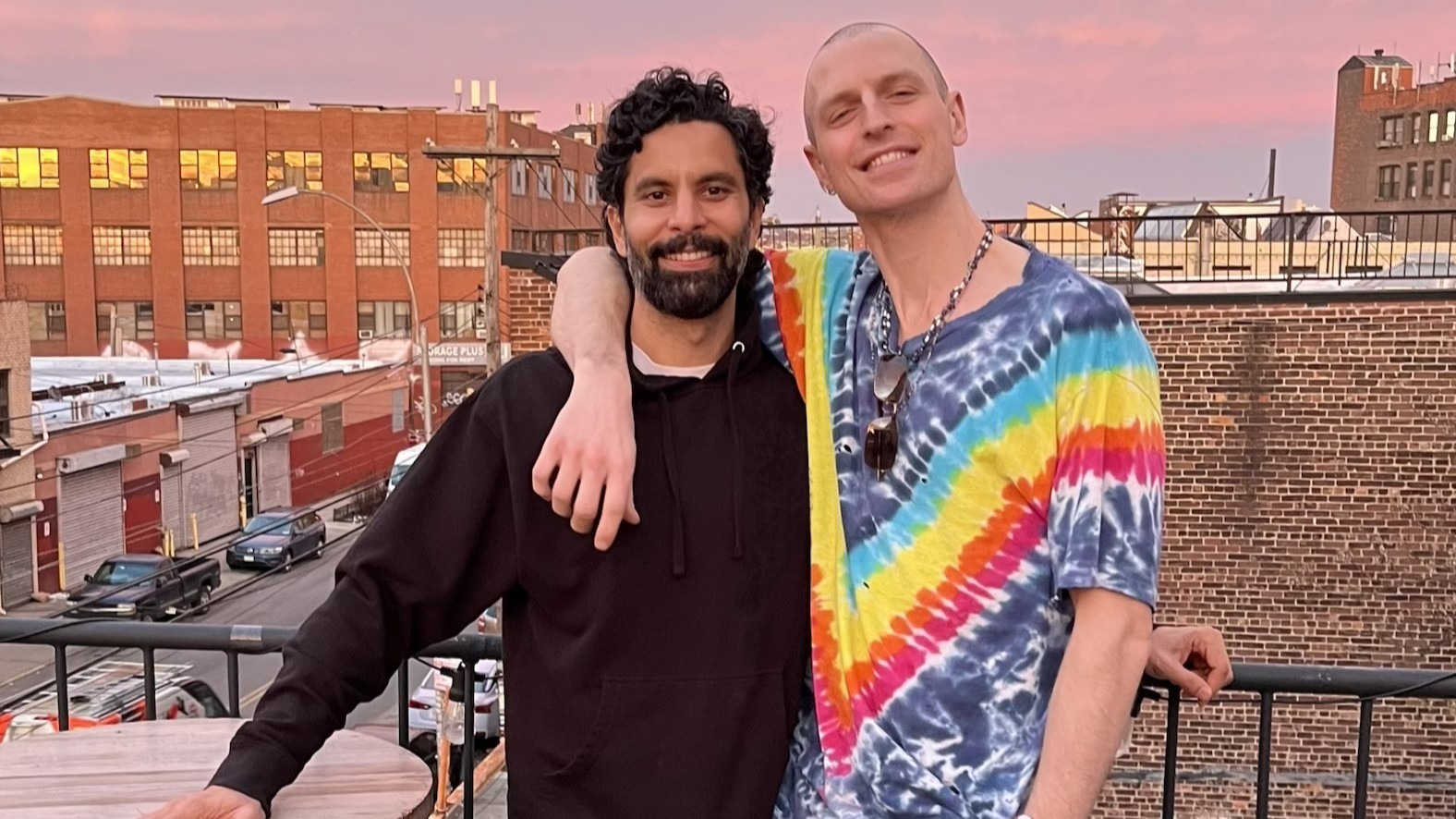 Daniel Donigan, right, wearing a Pride T-shirt, has his arm around his fiancé Veer Nanavatty