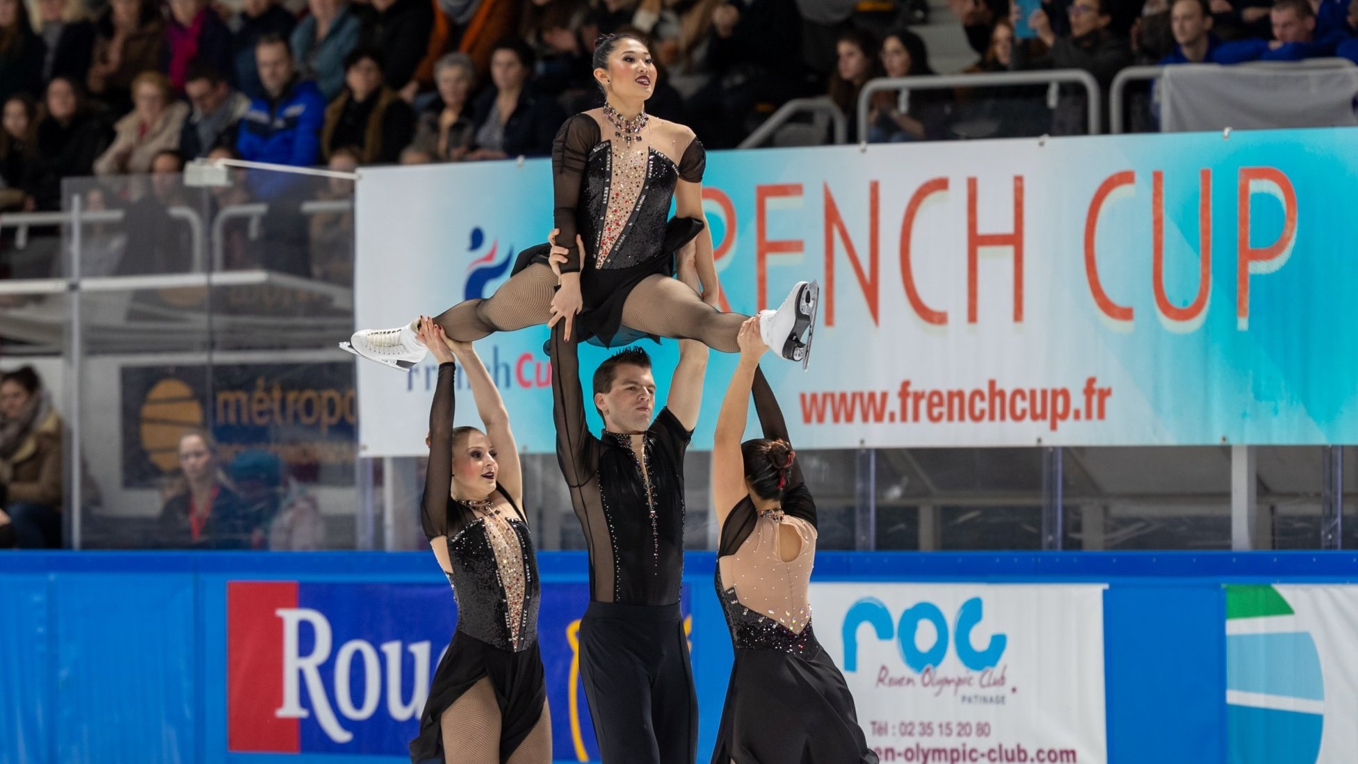 Eri Lee is lifted high into the air by her Haydenette teammates.