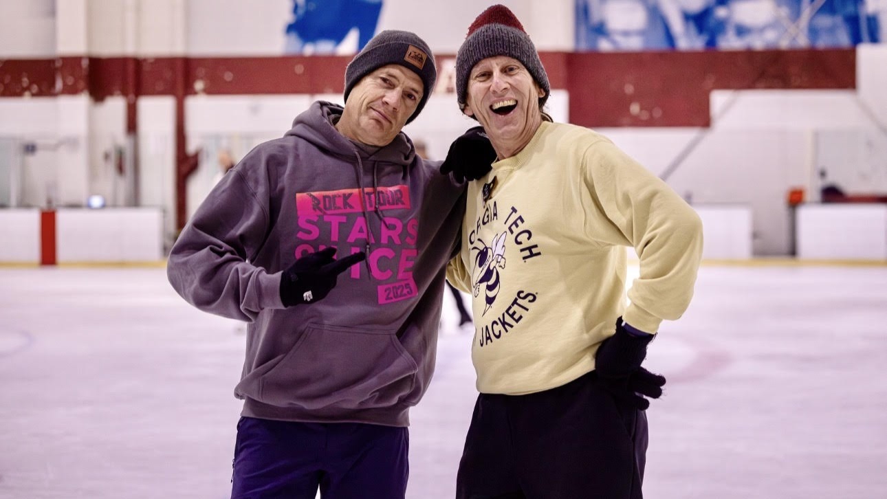 Stan Kimer, right, wearing a gold Georgia Tech sweatshirt, stands next to Olympian Kurt Browning on the ice.