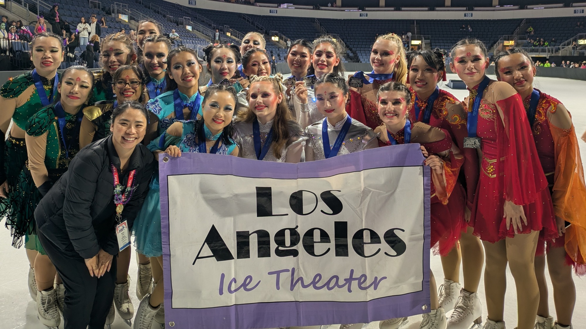 Group photo of Los Angeles Ice Theatre holding up banner