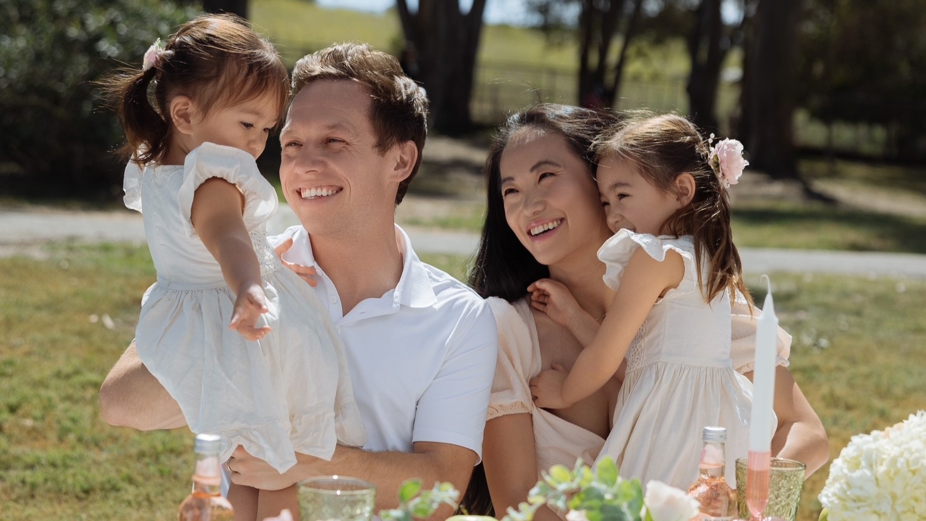 Grant Hochstein and wife Caroline Zhang, hold daughters Charlotte and Clara
