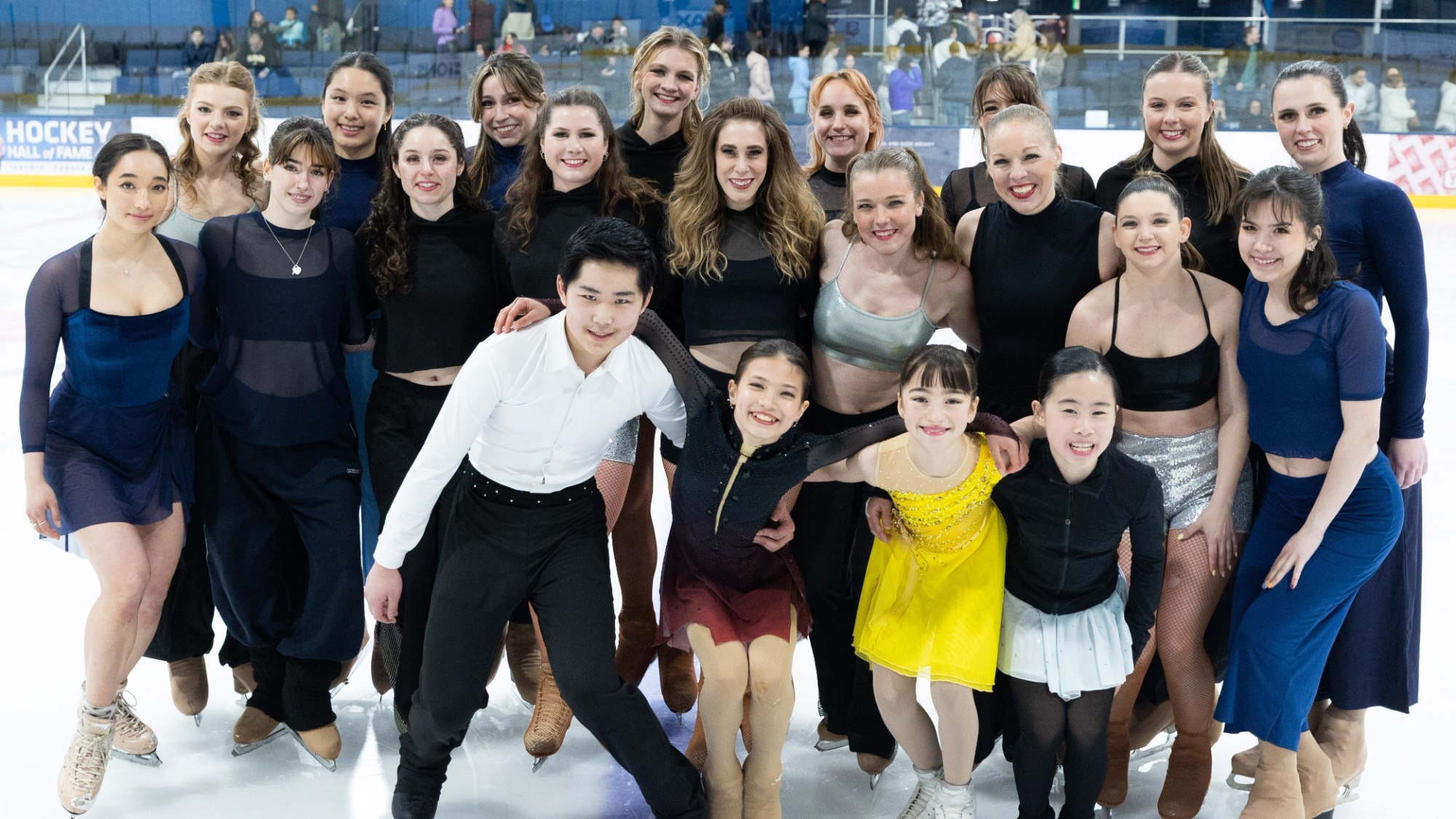 The cast of Skate Against Hate stands together on the ice
