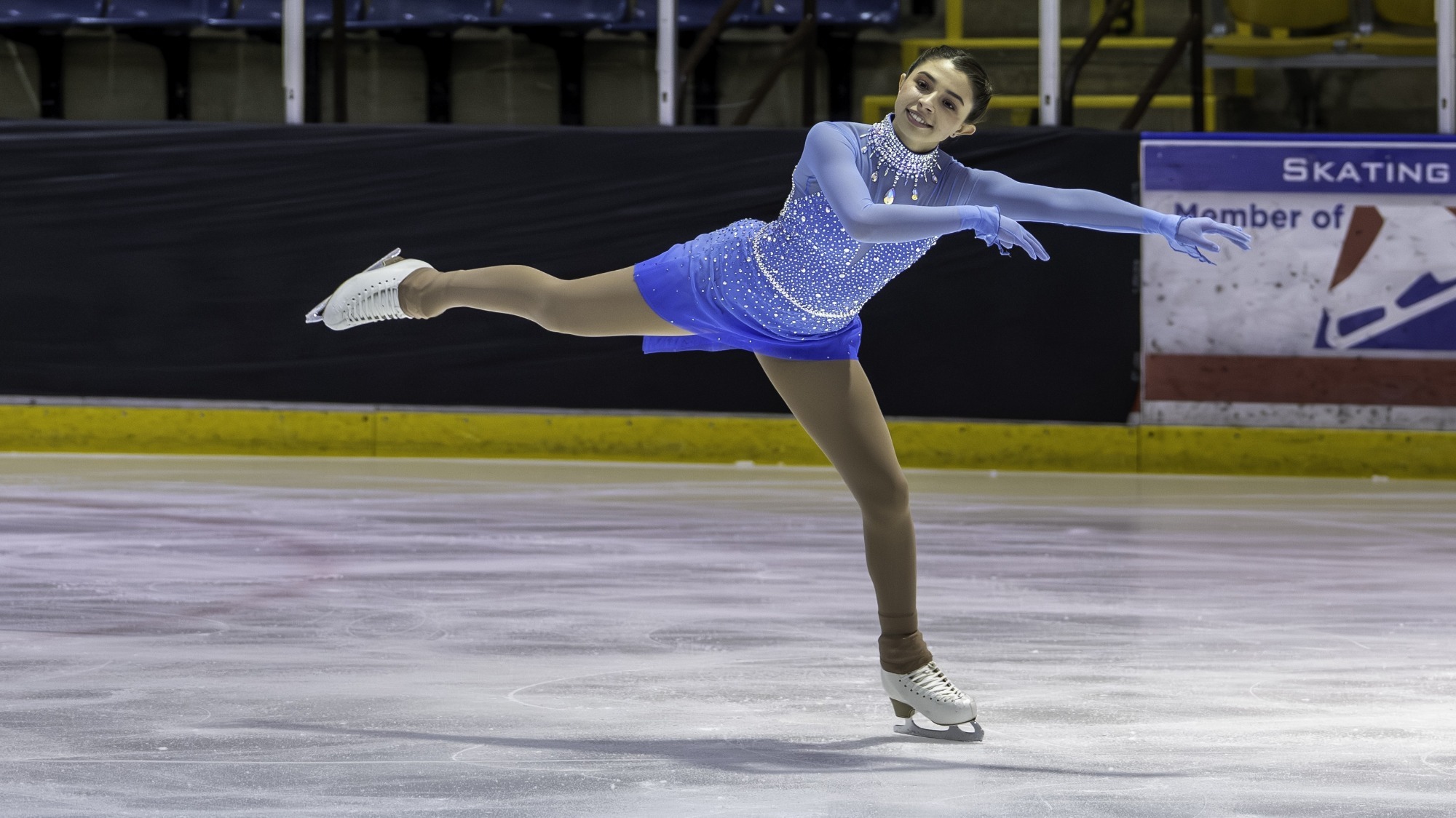 Gwendolyn Vignato glides across the ice in her light blue dress at the Excel Final.