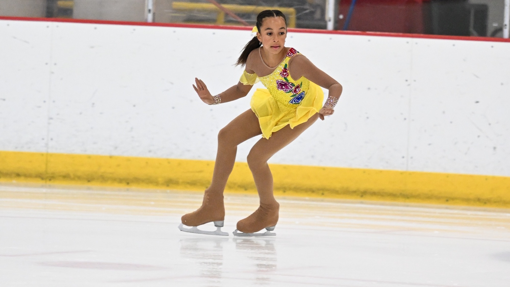Skylar Lautowa-Peguero, wearing a yellow costume, performs at the U.S. Junior Team Cup in Milwaukee, Wisconsin