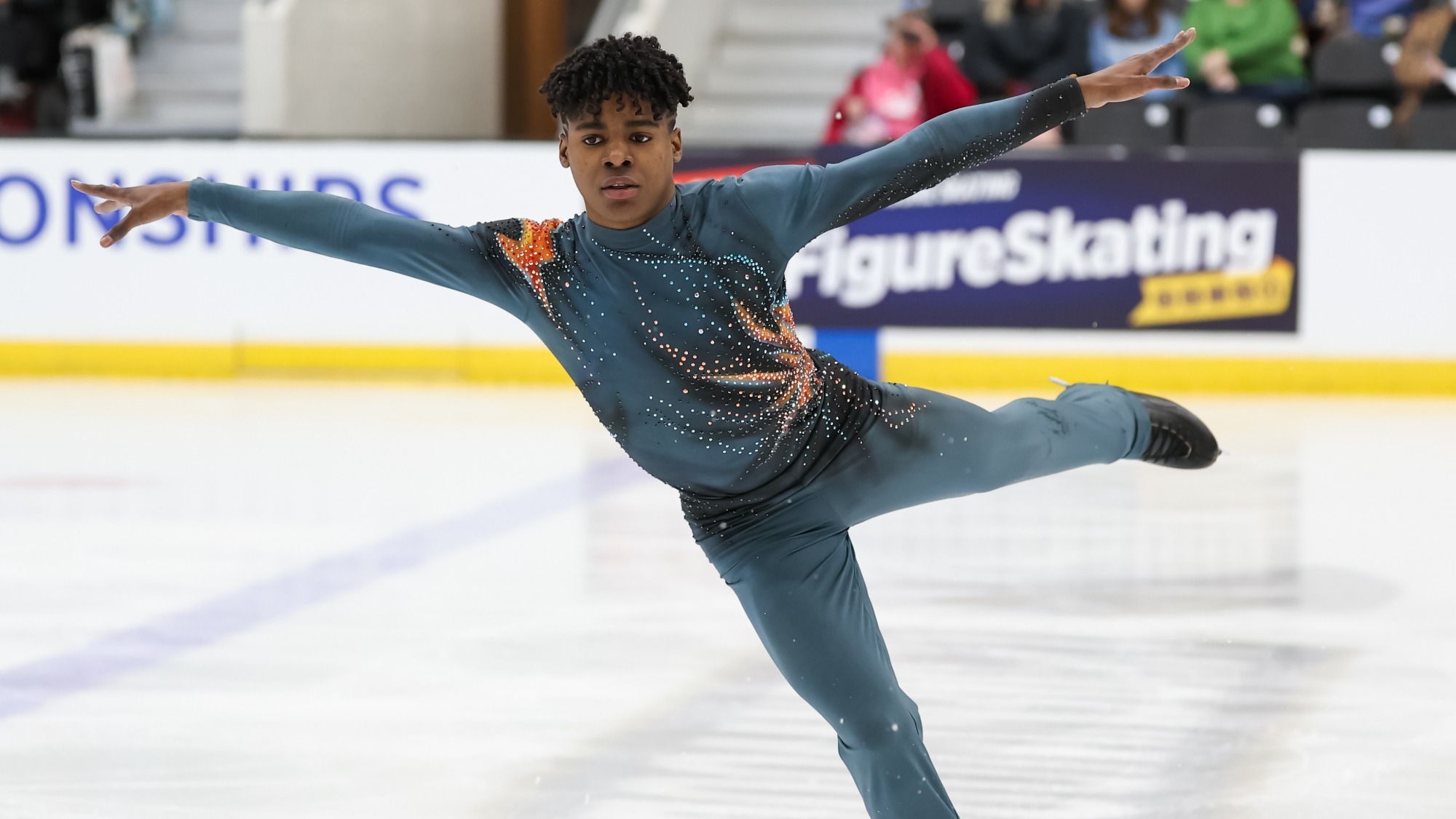 Caleb Farrington, arms extended, skates at the 2026 U.S. Championships. 