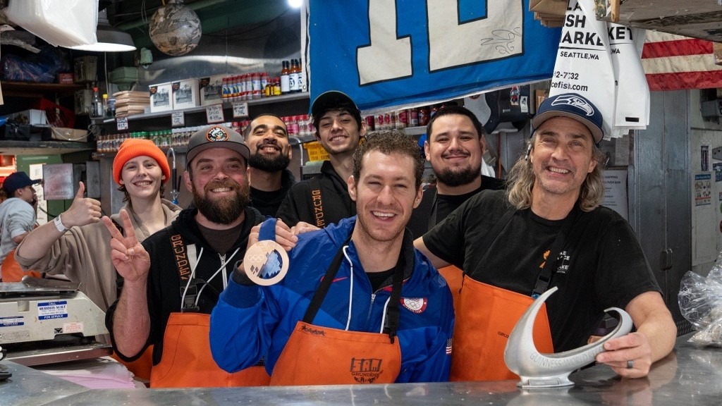 Jason Brown has some fun with the employees at the Pike Place Fish Market in Seattle.