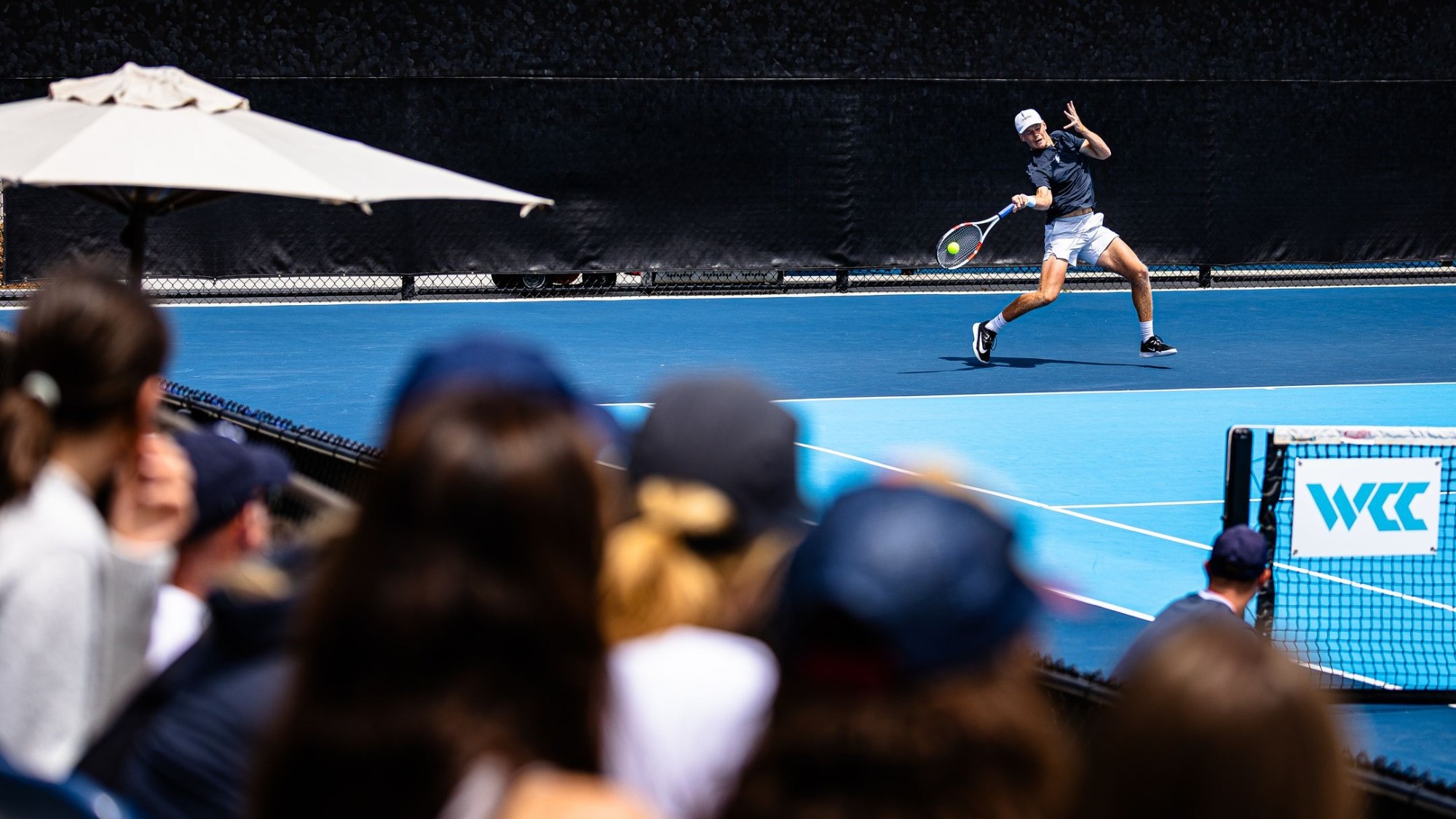 Lambert Ruland Action in front of crowd at Hogan Tennis Center