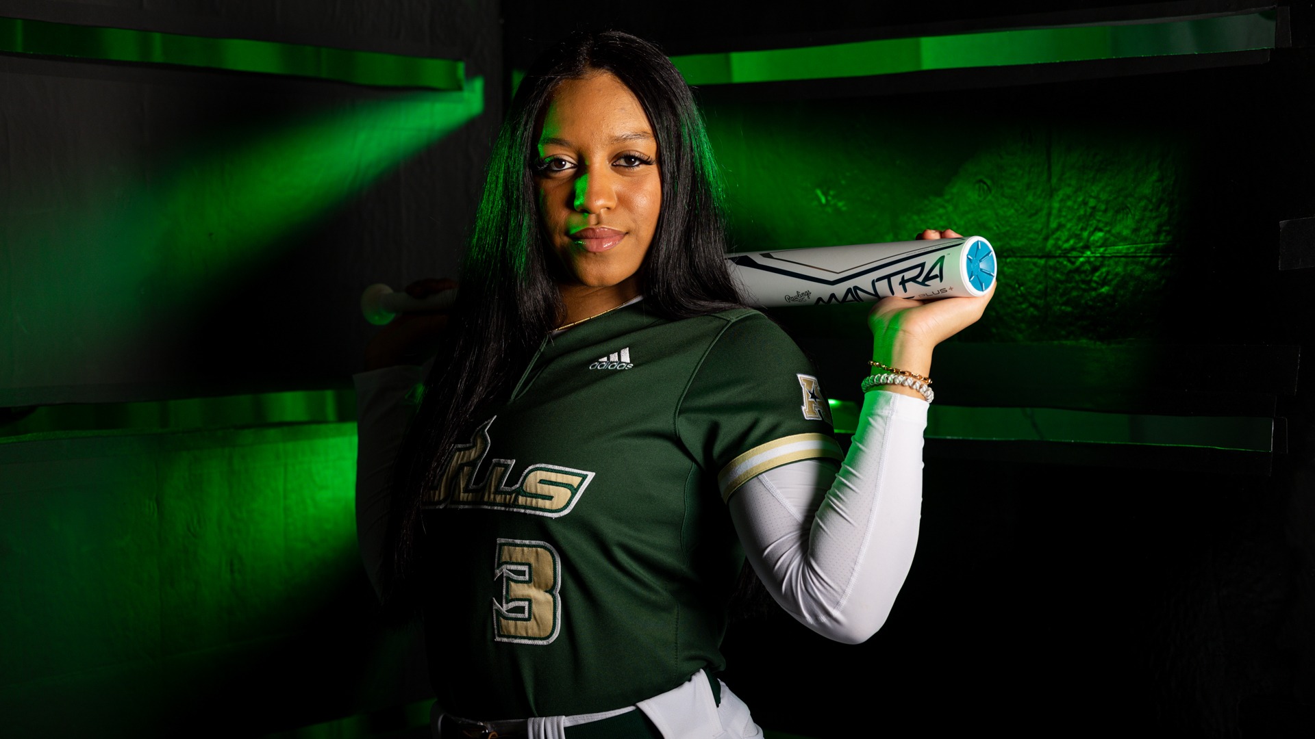 Tieley Vaughn during a preseason photo shoot with her bat across her shoulders.