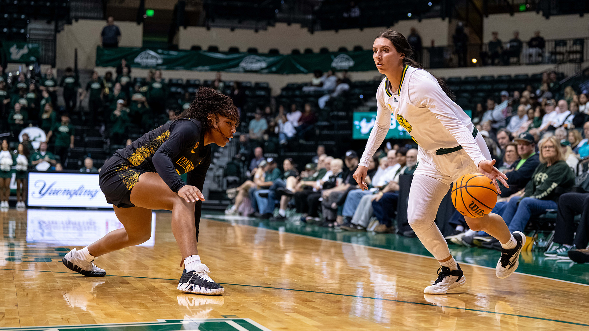 WBB Katie Davidson driving to the basket after causing the defender to fall down