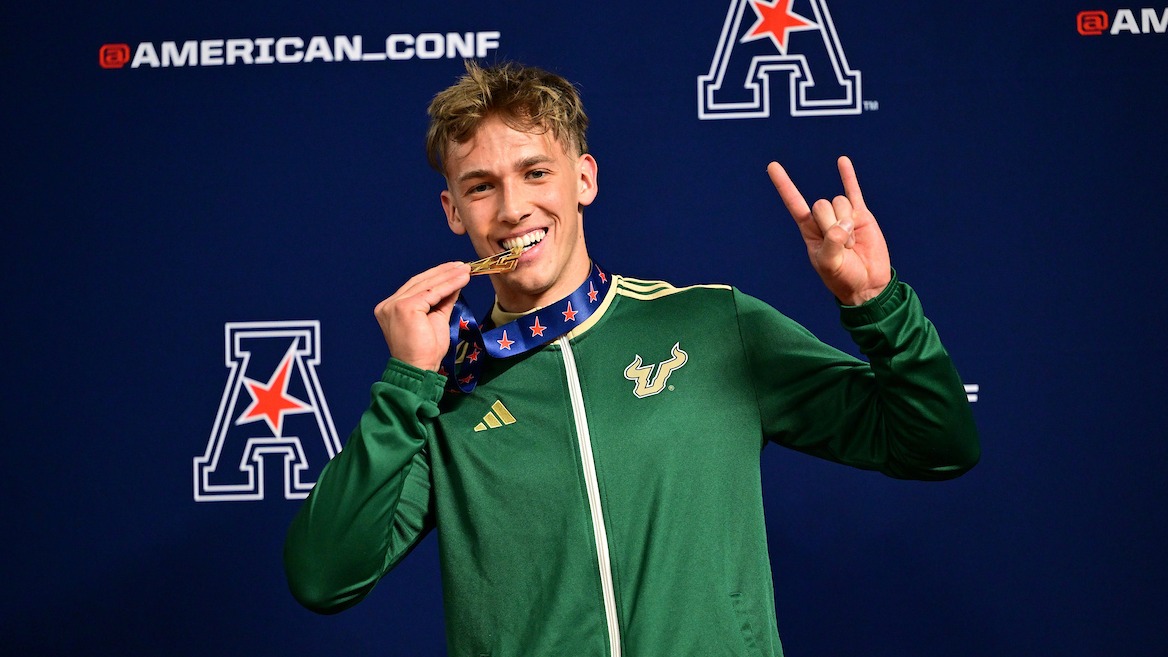 Nikodem Pochopien Biting Medal Podium - American Indoor Men's Pole Vault Champion